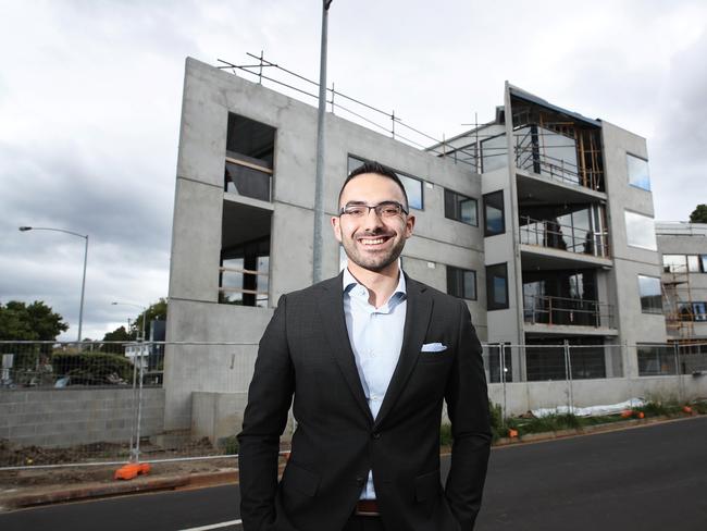 Hobart City Council Alderman Simon Behrakis standing in front of a new multi-residential development in Sandy Bay. Picture: LUKE BOWDEN