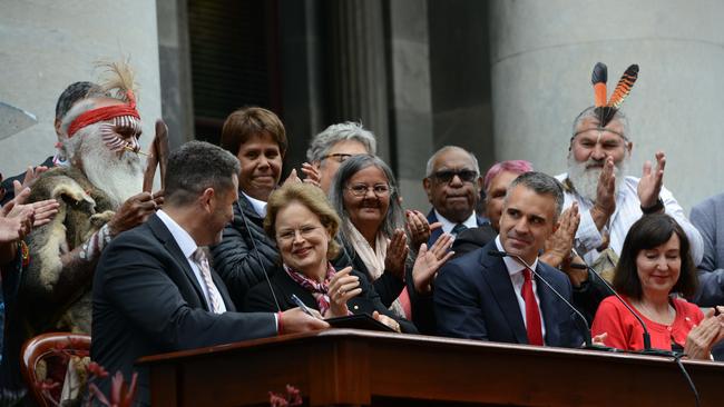 SA Attorney General Kyam Maher, left, Governor Frances Adamson, Premier Peter Malinauskas and deputy Premier Susan Close sign the bill on the steps of Parliament House to pass the nation’s first voice to parliament.