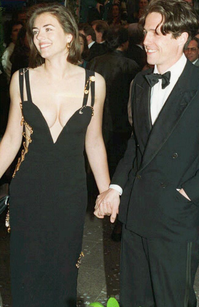 Elizabeth Hurley with Hugh Grant debuts “that dress”  on the red carpet for Four Weddings And A Funeral.