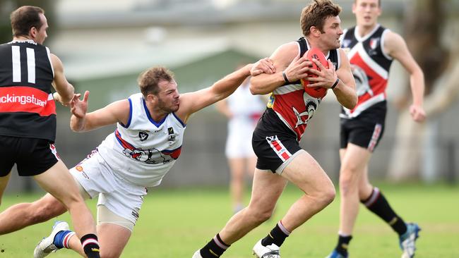 Bonbeach’s Gary Carpenter shrugs off Mornington’s Pete McGettigan. Picture: Chris Eastman