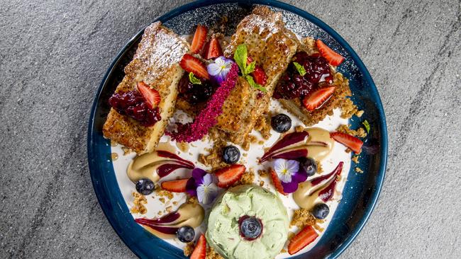 French toast has become the top seller at Cardamom Pod Brickworks. The chia drenched French toast with roast green apple ice cream, blackberry compote, salted caramel sauce and Anzac cookie crumble. Picture: Jerad Williams