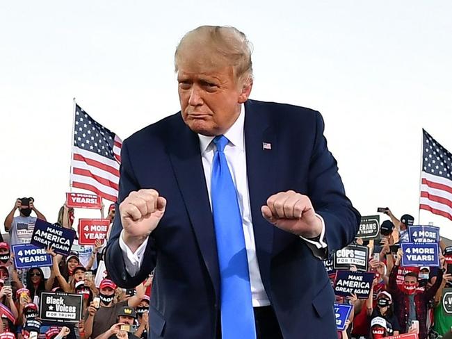 (FILES) In this file photo taken on October 18, 2020 US President Donald Trump dances at the end of a rally at Carson City Airport in Carson City, Nevada. - US election day is quickly approaching, but this week has shown there's still plenty of time for dancing and video games on the campaign trail. (Photo by MANDEL NGAN / AFP)