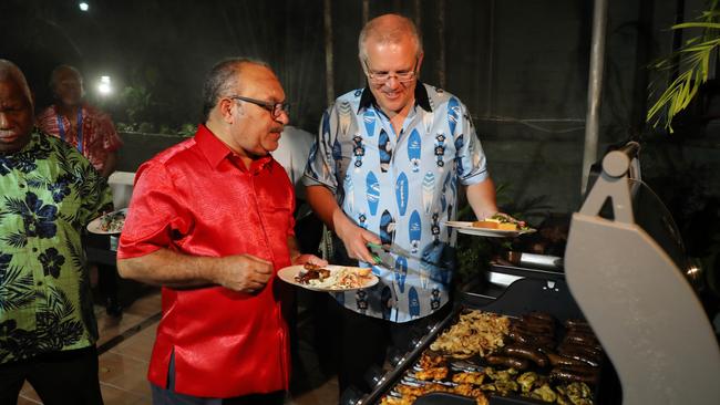 Scott Morrison with PNG Prime Minister Peter O’Neill at a barbecue at the Australian high commissioner’s home in Port Moresby last night. Picture: Adam Taylor