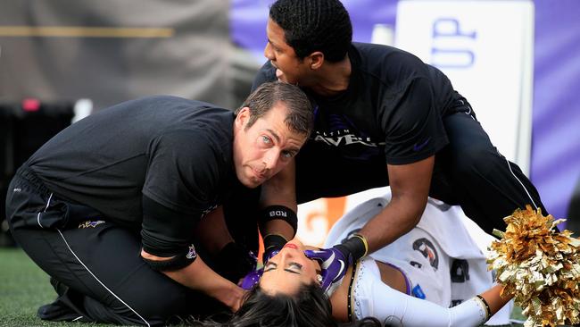 BALTIMORE, MD - NOVEMBER 09: A Ravens cheerleader is tended to after falling during a game between the Baltimore Ravens and Tennessee Titans at M&T Bank Stadium on November 9, 2014 in Baltimore, Maryland. Rob Carr/Getty Images/AFP == FOR NEWSPAPERS, INTERNET, TELCOS & TELEVISION USE ONLY ==