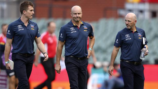 Matthew Nicks (centre) walks back to the coaches box after the halftime break during his first game as coach, against Sydney. Picture: Sarah Reed