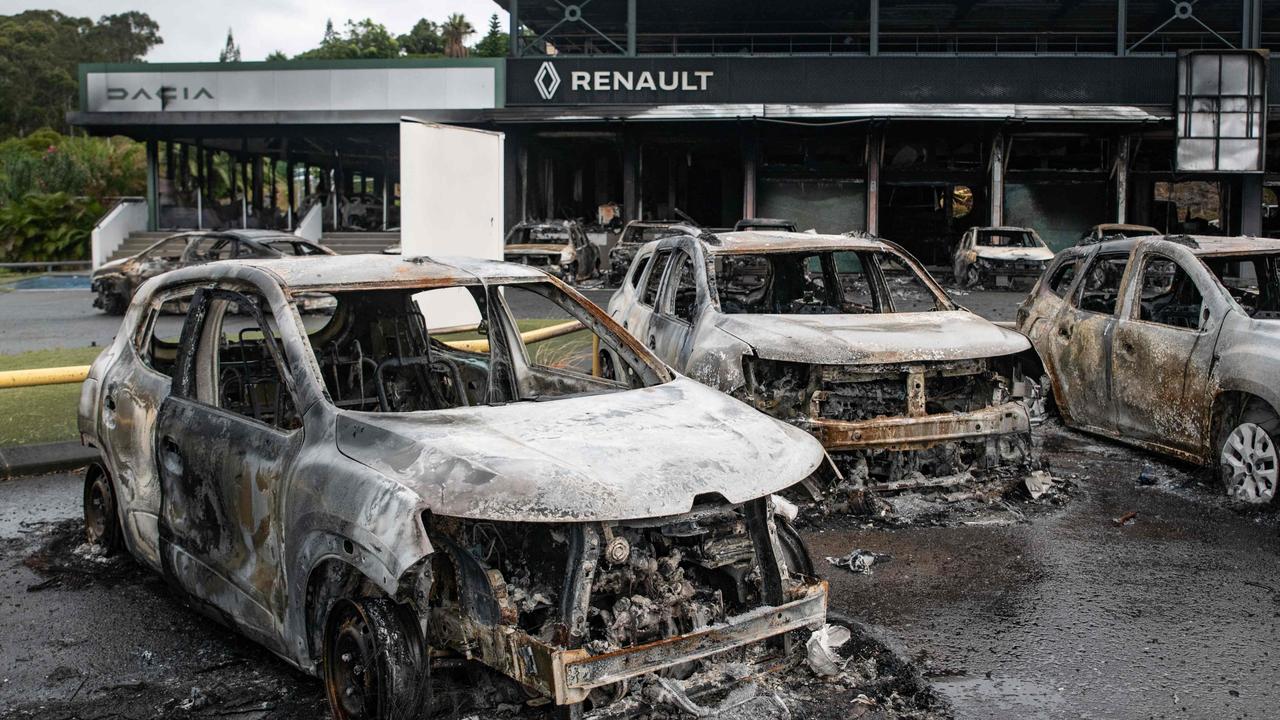 Burnt cars of the Renault Dacia parking lot in Noumea, New Caledonia. Picture: Delphine Mayeur/AFP