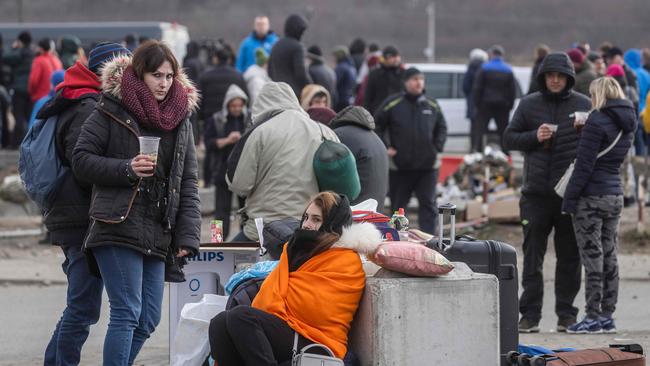 Ukrainian citizens are seen arriving at the Medyka pedestrian border crossing. Picture: Wojtek Radwanski/AFP