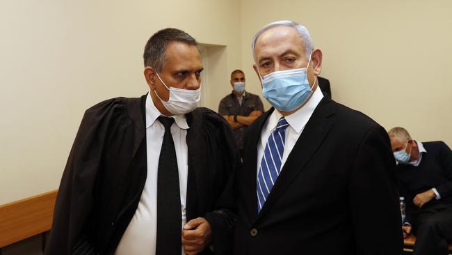 Israeli Prime Minister Benjamin Netanyahu, right, with one of his legal team in the Jerusalem District Court on Sunday. Picture: AP