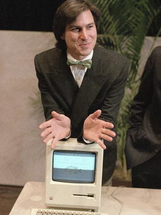 Steve Jobs leans on the new Macintosh personal computer in 1984. Picture: AP