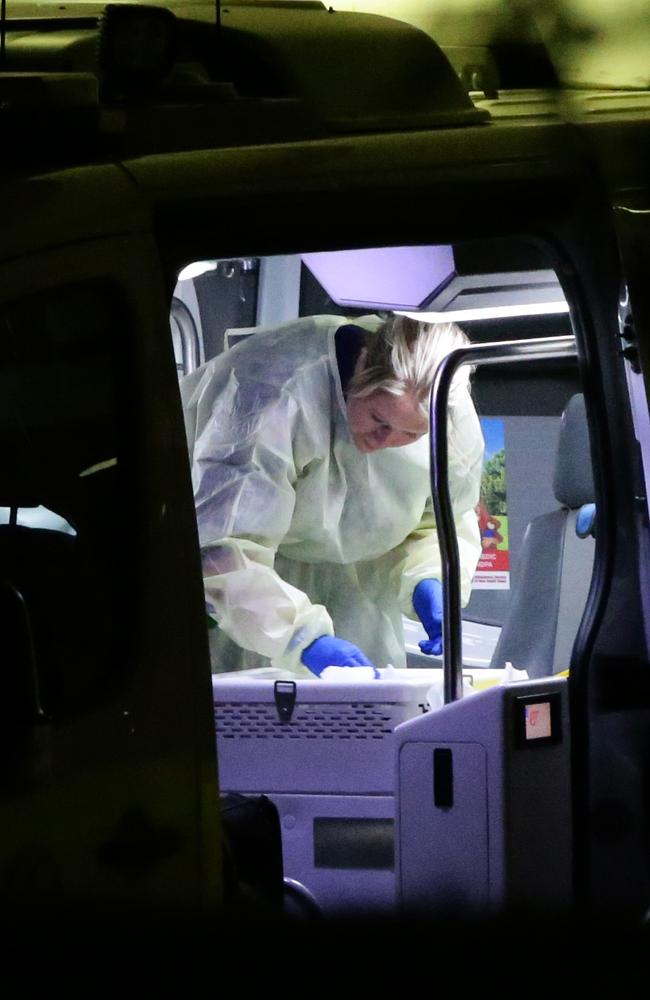 A paramedic decontaminates an ambulance after transporting a man with a possible case of coronavirus to a Sydney hospital overnight. Picture: Bill Hearne