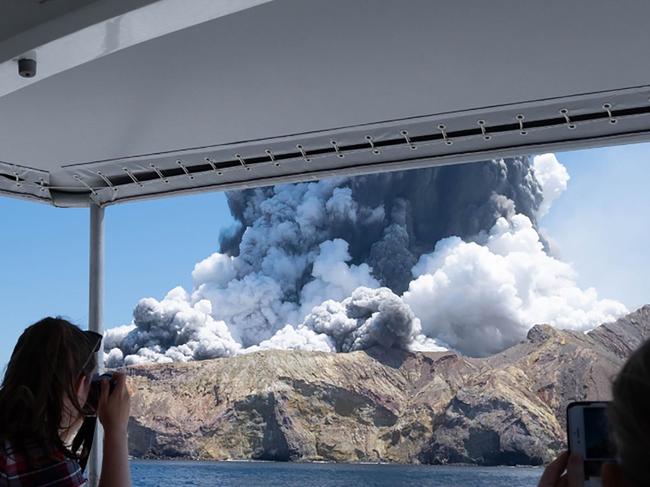 The volcano on New Zealand's White Island spews steam and ash moments after it erupted. Picture: AFP/Michael Schade