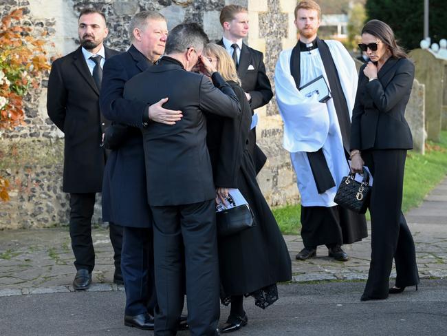 Simon Cowell is comforted by Geoff Payne (L) as they depart the funeral. Picture: WireImage