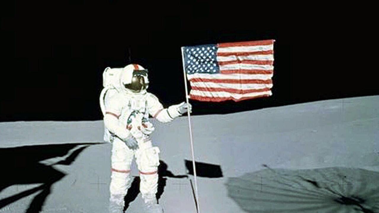 Astronaut Alan Shepard stands with USA Flag on Lunar Surface, the fifth human to walk on the moon. Picture: NASA