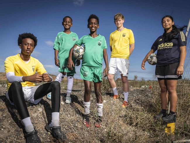 Abdulamilk Yusuf (14), Zak Yusuf (9), Yussuf Hussein (11), Flynn Slater (15) and Madison Pavez (13) in the spot where a new soccer facilities will be built in Tarneit. Picture: Jake Nowakowski