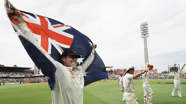 Australia's Matthew Hayden holds up the Australian flag as he celebrates with his teammates after Australia regained the Ashes. (AAP Image/Dean Lewins)