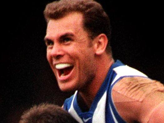 Grand Final Kangaroos vs Carlton : Kangaroos' Wayne Carey (R) leaps into the arms of Corey McKernan 25 Sept 1999 - sport AFL action victory celebrations