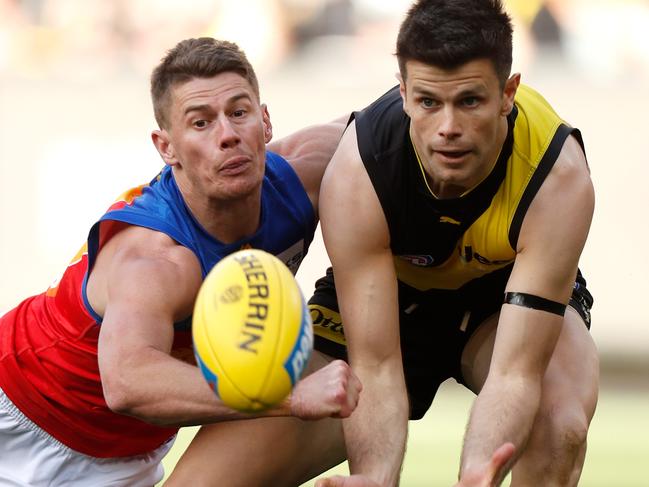 MELBOURNE, AUSTRALIA - AUGUST 25: Trent Cotchin of the Tigers and Dayne Zorko of the Lions in action during the 2019 AFL round 23 match between the Richmond Tigers and the Brisbane Lions at the Melbourne Cricket Ground on August 25, 2019 in Melbourne, Australia. (Photo by Michael Willson/AFL Photos via Getty Images)