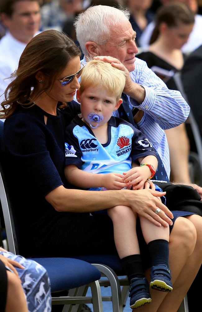 Sarah Vickerman with younger son Xavier and her father today at the memorial service to her late husband. Picture: Mark Evans