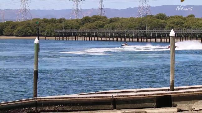 Jet skiers hoon on the Port River