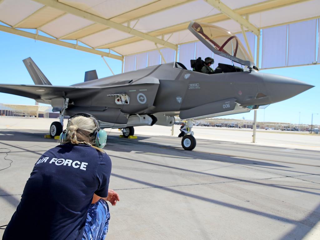 Australian Pilots training in the F35 fighter Jets Luke Airforce Base in Phoenix Arizona. Squadron leader call sign “Belly” talks to RAAF Corp Lorna Hill who is part of the maintenance and ground crew team before a flight. Picture: Nathan Edwards