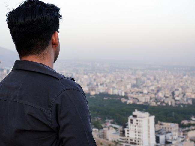 A man gazes down on the resort area and Tehran from the Tochal mountain. Pocture: AFP