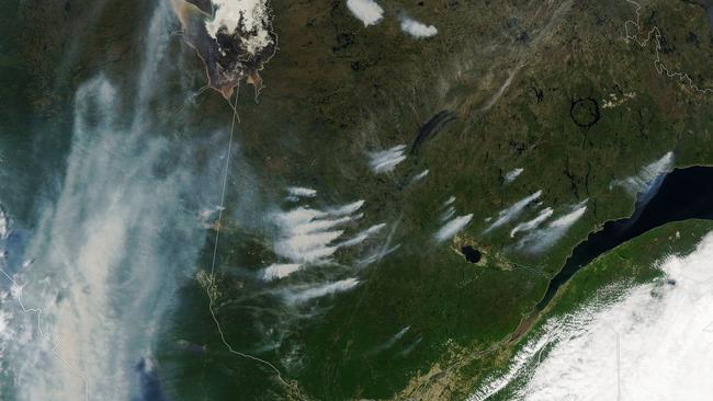 NASA image of bushfires burning over Quebec with the plumes of smoke visible. Picture: NASA Earth Observatory image by Lauren Dauphin.