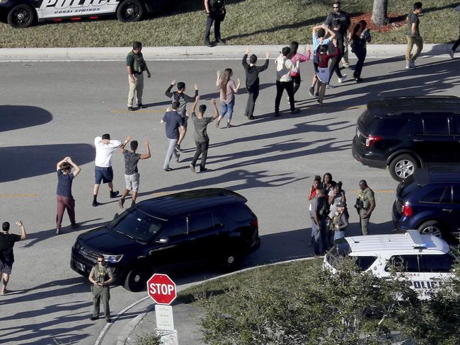 Students flee the scene of the shooting. Picture: AP