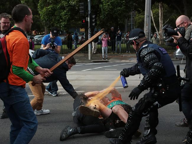 Police pepper spray protesters outside the show at the Melbourne Pavilion. Picture: AAP