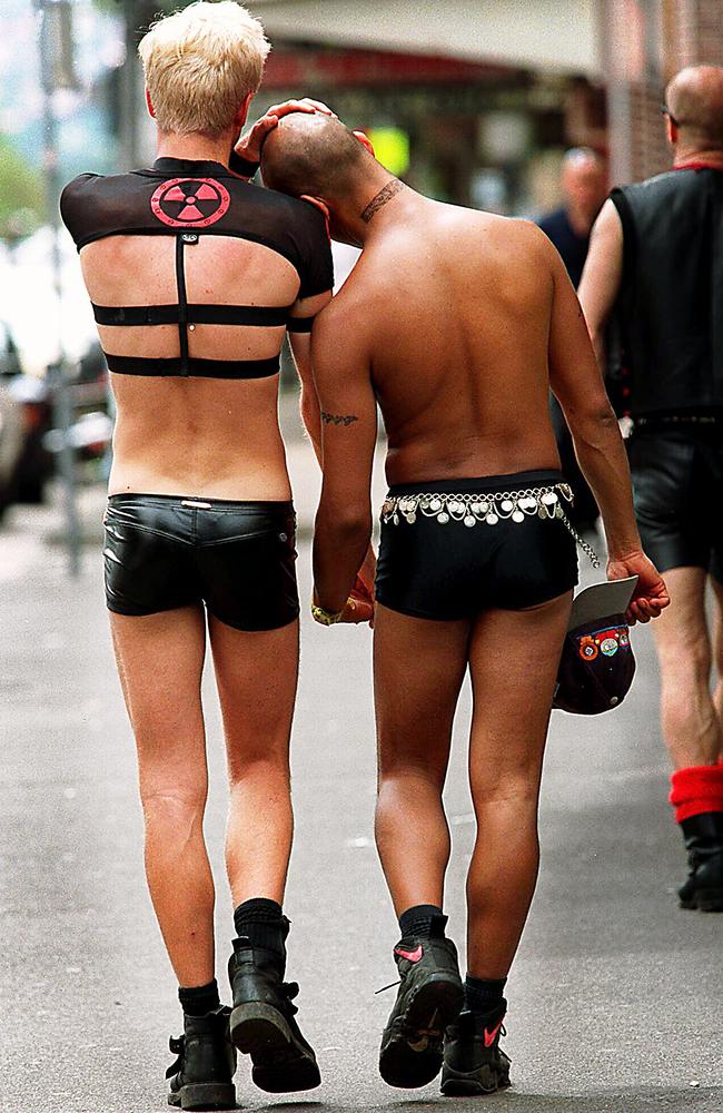 Jamieson Adcock and his partner, Paul Cordeiro, wander down Bourke Street after a heavy night celebrating. Picture: Pip Blackwood