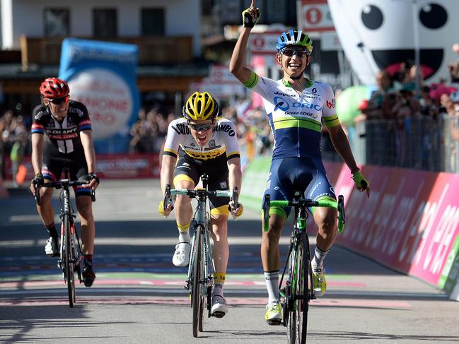 Colombian cyclist Esteban Chaves, right, celebrates on the finish line of the 14th stage of the Giro D'Italia, Tour of Italy cycling race from Alpago to Corvara, Saturday, May 21, 2016. Esteban Chaves, a Colombian with Orica Greenedge, won the 14th leg in a three-man sprint. (Luca Zennaro/ANSA via AP)