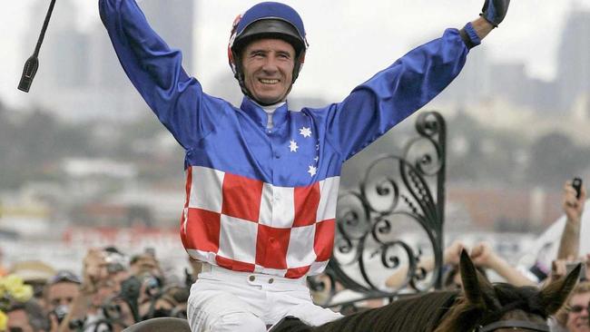 Australian jockey Glen Boss celebrates in the mounting Yard after winning the Melbourne Cup on Makybe Diva  at Flemington Racecourse, Melbourne Australia, Tuesday, Nov. 1, 2005. Makybe Diva, a seven-year-old English-born mare, become the first horse to win Australia's richest and most famous race three times in a row, scoring a stirring victory in Tuesday's Melbourne Cup at Flemington. (AP Photo/ Tony Feder). Picture: TONY FEDER