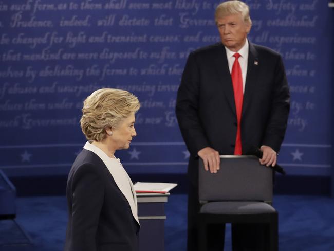 In this file photo, Democratic presidential nominee Hillary Clinton walks past Republican presidential nominee Donald Trump. Picture: AP.