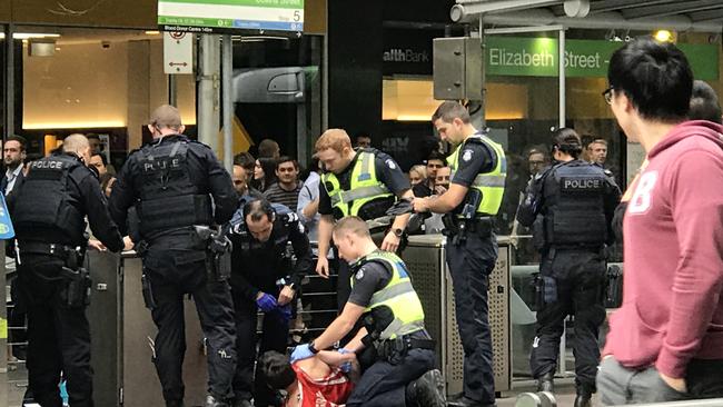 Police making the arrest in the CBD this afternoon. Picture: Mikaela Day