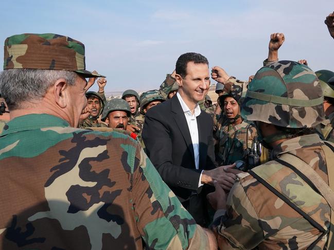 Syrian soldiers cheer President Bashar al-Assad. Picture: AFP