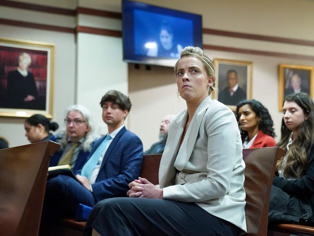 Whitney Henriquez, sister of actor Amber Heard, watches a previously recorded video deposition by her sister's make-up artist, Melanie Inglessis, after testifying herself. Picture: Kevin Lamarque/ AFP.