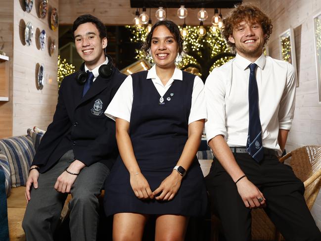 Natayleah Georgetown’s fellow scholarship recipients, Shannon Rogers, left, and Daniil Bloshenko, right, are also the first in their respective families to graduate high school. Picture: Richard Dobson