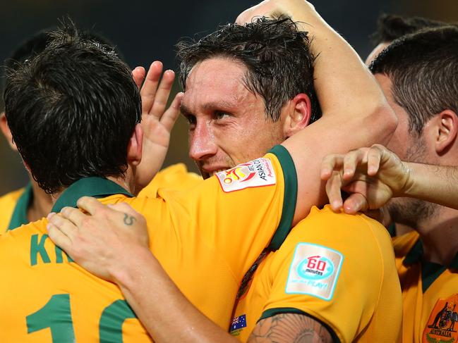 SYDNEY, AUSTRALIA - JANUARY 13: Mark Milligan of Australia celebrates with team mates after scoring a goal during the 2015 Asian Cup match between Oman and Australia at ANZ Stadium on January 13, 2015 in Sydney, Australia. (Photo by Brendon Thorne/Getty Images)