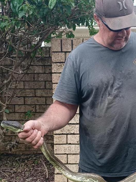 Ben Blake, with the snake that attacked his son.