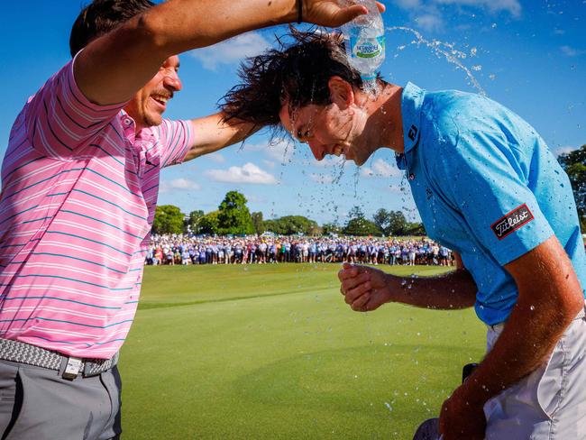 Elvis Smylie (R) celebrates winning the Australian PGA Championship. Picture: Patrick Hamilton/AFP