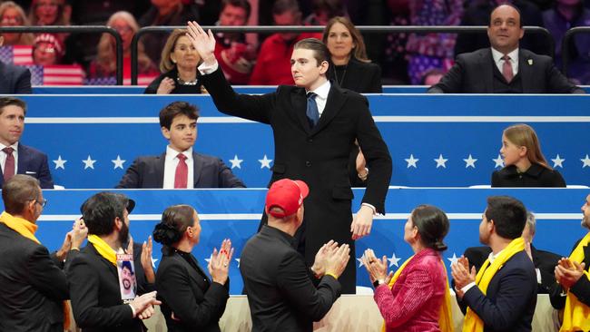 Barron Trump gestures as he is recognised during the indoor inauguration parade. Picture: Getty Images/AFP