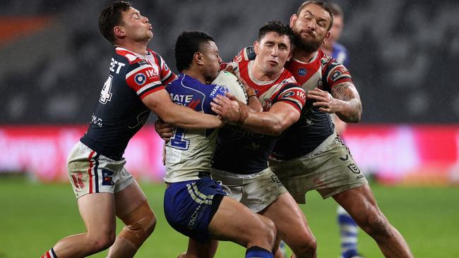 Falakiko Manu of the Bulldogs is tackled during the round 17 NRL match between the Canterbury Bulldogs and the Sydney Roosters at Bankwest Stadium on Saturday night. There are calls to move the entire NRL comp out of NSW. Picture: Cameron Spencer/Getty Images