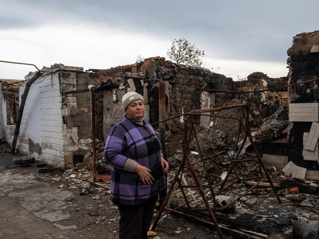 A retired local teacher stands next to her house that was destroyed during fighting between Ukrainian and Russian occupying force. Picture: Getty Images