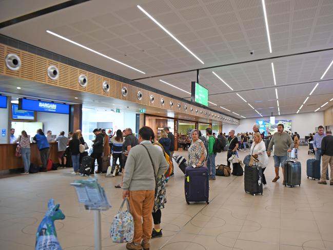 HOBART, AUSTRALIA - MARCH 19: Passengers line up for hire cars at Hobart airport on March 19, 2020 in Hobart, Australia. The Tasmanian premier Peter Gutwein has announced all interstate travellers will be required to quarantine for 14 days. The measures are the toughest to be imposed in Australia, and will come into effect from Friday 20 March. There are now 596 confirmed cases of COVID-19 In Australia, while there have been six confirmed deaths, five in NSW and one in Western Australia. (Photo by Steve Bell/Getty Images)