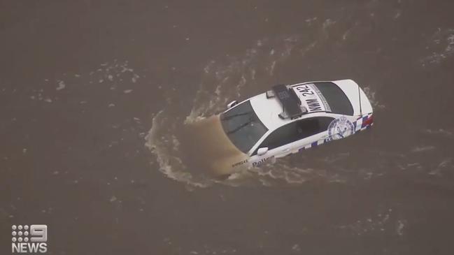 A police car is trapped in the flooded Hawkesbury River. Source: Nine News via Twitter