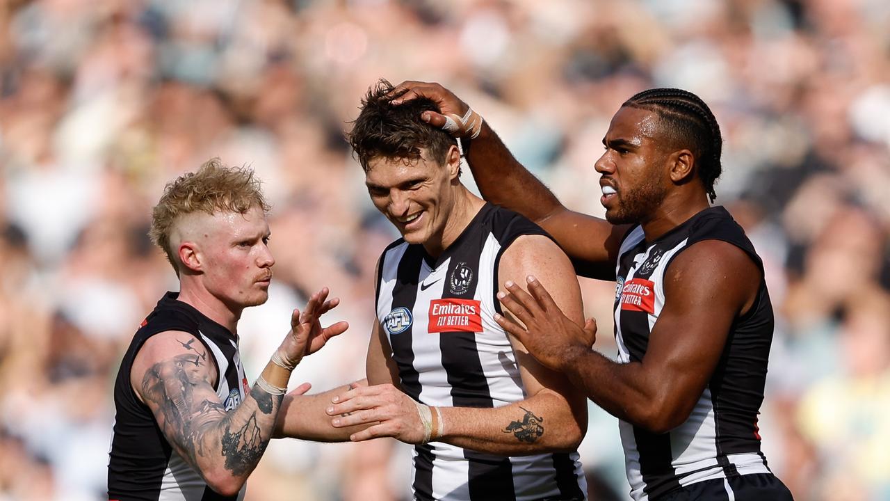 Brody Mihocek (centre) celebrates with teammates John Noble and Isaac Quaynor during the Pies’ huge comeback victory. (Photo by Dylan Burns/AFL Photos via Getty Images)