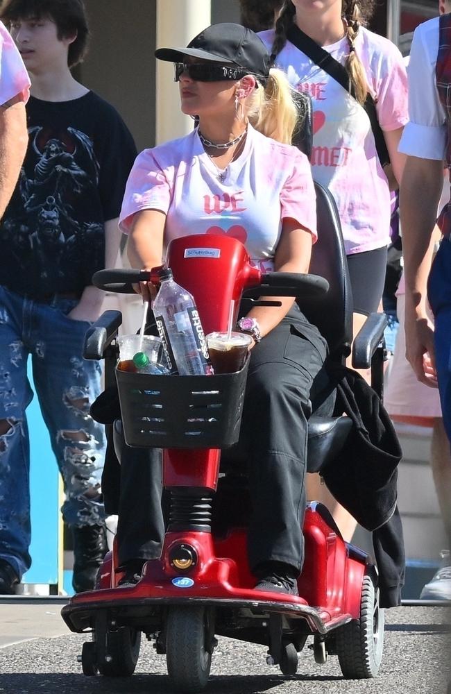 Christina Aguilera rides a mobility scooter while celebrating her daughter Summer's birthday at Disneyland in California. Picture: Backgrid