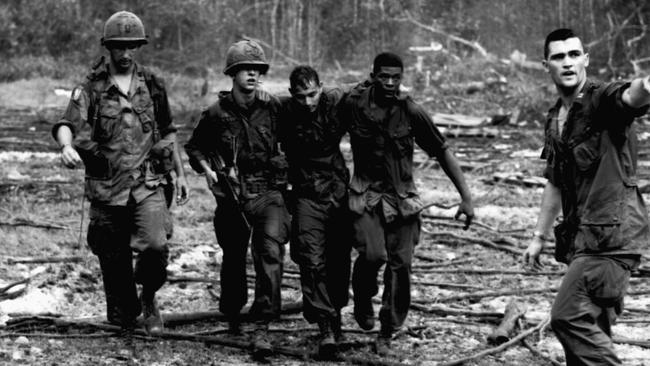 Tim Page’s photo of a battle-weary soldier being assisted after the battle for Zulu Zulu in Vietnam, 1966. Picture: Getty Images