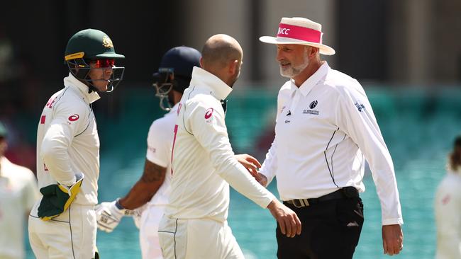 Tim Paine and Nathan Lyon of Australia questions umpire Paul Wilson over a DRS referral in a test match against India. Picture: Ryan Pierse/Getty Images