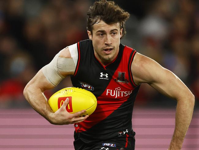 MELBOURNE, AUSTRALIA - JULY 17: Andrew McGrath of the Bombers runs with the ball during the round 18 AFL match between the Essendon Bombers and the Gold Coast Suns at Marvel Stadium on July 17, 2022 in Melbourne, Australia. (Photo by Daniel Pockett/Getty Images)