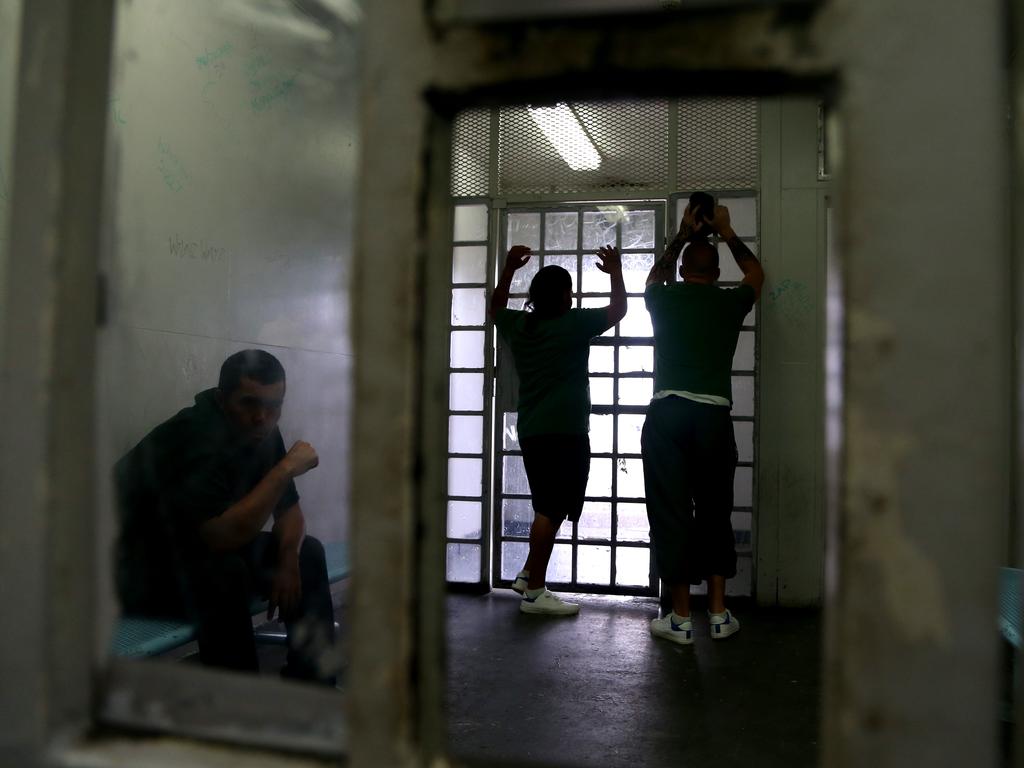 Prisoners wait in a holding cell while in the process of being transfered for a court appearance or to another jail. Picture: Adam Taylor